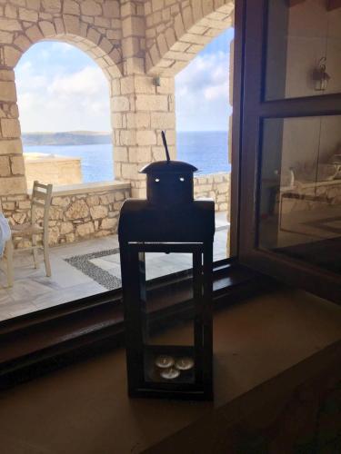 a stove in a room with a view of the ocean at Stonehouse villas with breathtaking view in Sitia