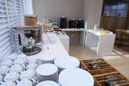 a kitchen with white plates and dishes on a counter at Agua del Corral Hotel & Spa in Mendoza