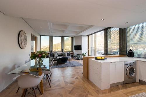 a kitchen and living room with a glass table at #1803 Cartwright - Simply Spectacular in Cape Town