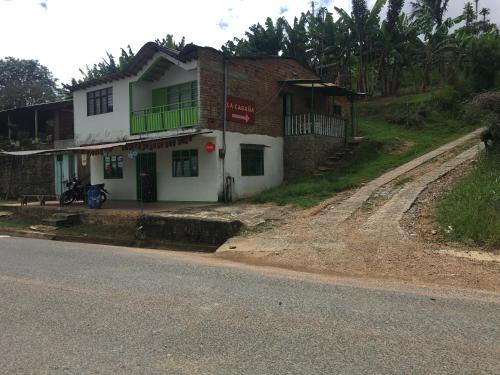 a building on the side of a road at La cabaña del lago Calima in Calima
