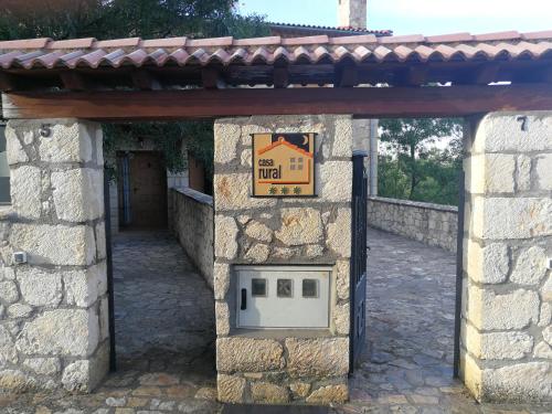 a stone building with a door with a sign on it at Las Casonas de Chavida in Chavida