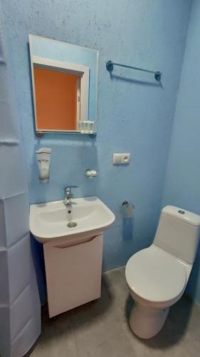 a bathroom with a white toilet and a sink at ICity Hills in Kutaisi
