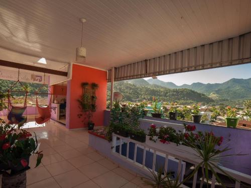 a flower shop with a view of the mountains at Pousada Lilás in Angra dos Reis