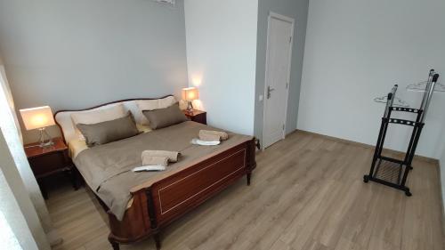 a bedroom with a bed with two towels on it at ICity Hills in Kutaisi