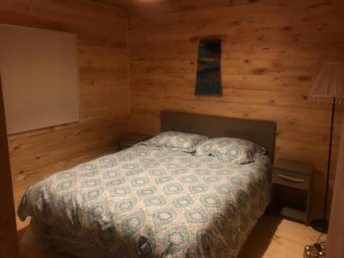 a bedroom with a bed in a log cabin at Cabañas entre montañas in Rari