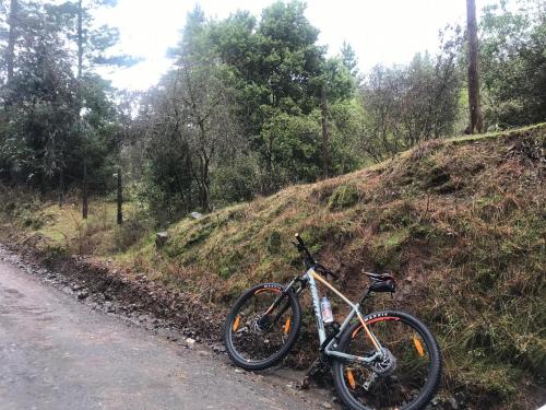 a bike parked on the side of a road at Cabañas entre montañas in Rari