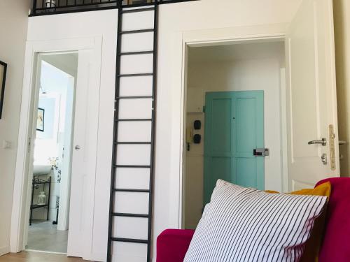 a room with a ladder leading into a room with a couch at CALIMARA18 25" from Florence AC SmartTV in Prato