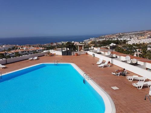 a pool on the roof of a building with a view at Village Island Heights in Adeje