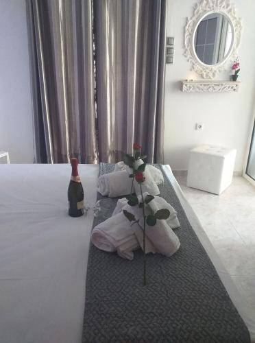 a hotel room with a bed with a flower on it at Aegean Blue in Panteli