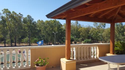 a porch with a white fence and a table at Don Antonio Residence in Sellia Marina