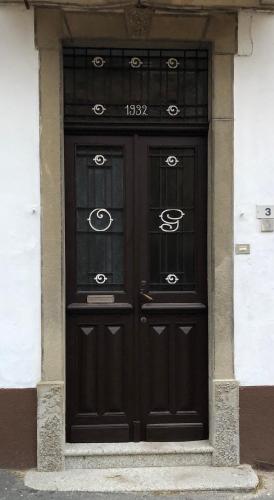 a large black door on a white building at Hotel Monte Mazzoccone in Quarna Sopra