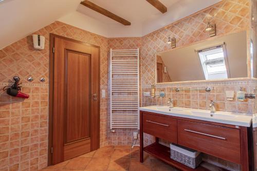 a bathroom with a sink and a mirror at Historický dům u lázní in Třeboň