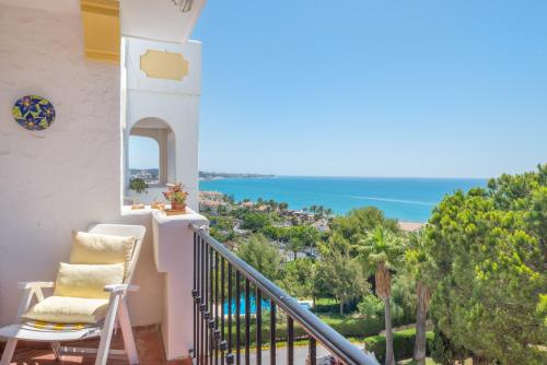 Un balcón con una silla y vistas al océano. en Beach Apartment Las Acacias Torrenueva, en La Cala de Mijas