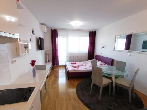 uma cozinha e uma sala de estar com uma mesa e uma sala de jantar em Lanterna Apartment em Zagreb