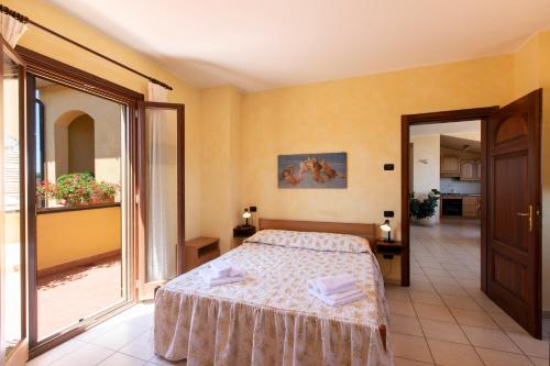 a bedroom with a bed and a balcony at B&B La Casa Fra Gli Olivi in Marsciano