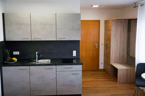 a kitchen with stainless steel cabinets and a sink at SP-Appartements in Neuhausen auf den Fildern