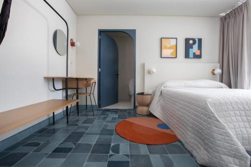 a bedroom with a bed and a desk and a table at Casa Ixaya by Barrio México in Guadalajara