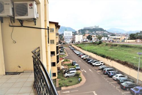 a view from a balcony of a parking lot at Appart TSINGA in Mokolo