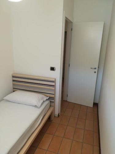 a small bedroom with a bed and a tiled floor at Luxury Villa Duna Verde in Duna Verde
