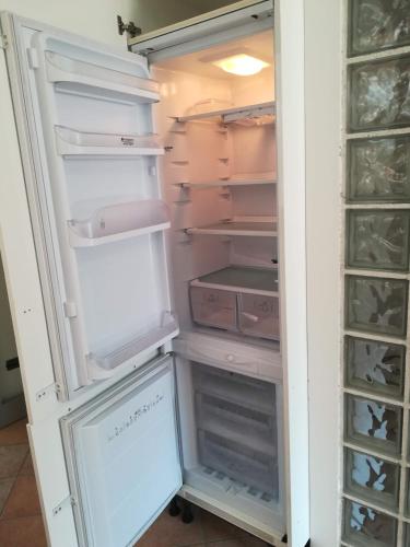 an empty refrigerator with its door open with its doorsktop at Luxury Villa Duna Verde in Duna Verde