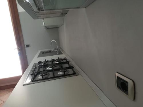 a stove top oven in a white kitchen at Luxury Villa Duna Verde in Duna Verde