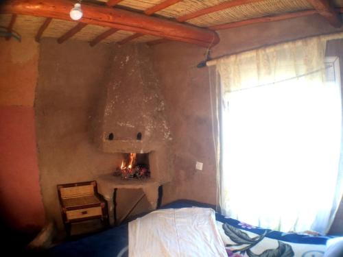a bedroom with a fire place in the wall at Dar Bejmate - Chez Hassan in Tacheddirt