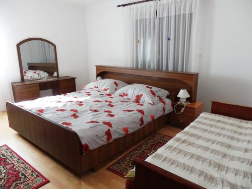 ein Schlafzimmer mit einem großen Bett und einem Spiegel in der Unterkunft Apartment Elida in Medulin