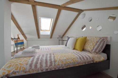 a bedroom with a king sized bed in a attic at Apartments Golden hour in Jurdani