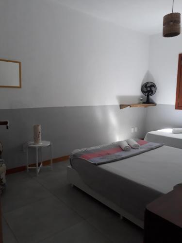 a bedroom with a bed and a sink in it at Mandacaru Guest House in Praia do Forte