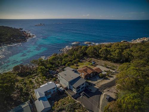 an aerial view of a house next to the ocean at The Cove Bay of Fires in Binalong Bay