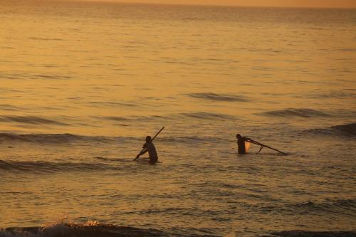 two people standing in the water in the ocean at Santa Sea Villa in Hoi An