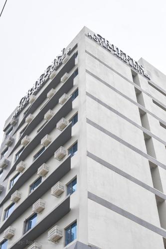 a tall white building with air conditioners on it at Griffin Hotel and Suites in Cebu City