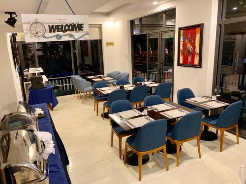 a row of tables and chairs in a restaurant at Santa Sea Villa in Hoi An