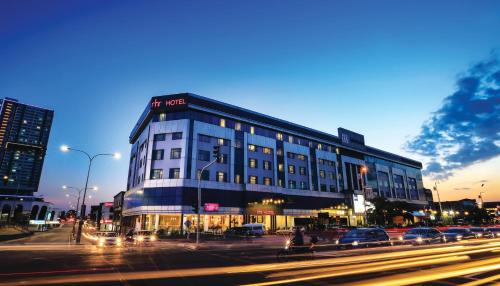 a large building on a city street at night at RHR Hotel Kajang in Kajang