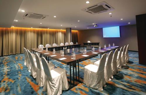 a conference room with a long table and chairs at RHR Hotel Kajang in Kajang