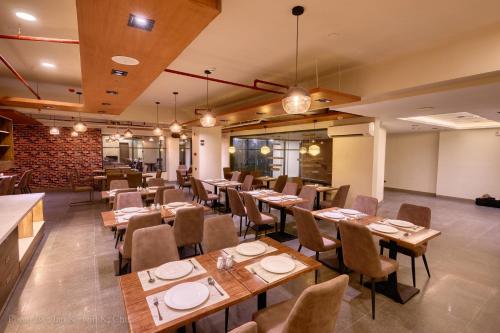 a dining room with wooden tables and chairs at Griffin Hotel and Suites in Cebu City