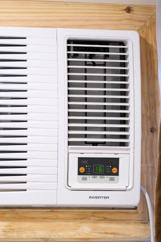a white air conditioner is sitting on a table at Griffin Hotel and Suites in Cebu City