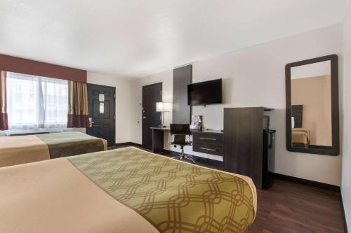 A bed or beds in a room at SureStay Hotel by Best Western Phoenix Airport