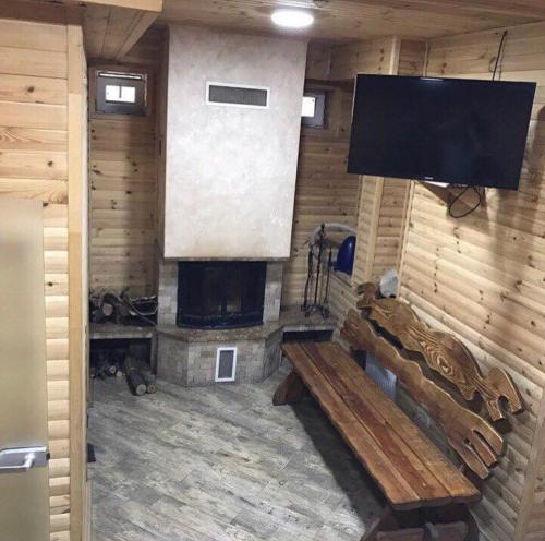 a living room with a fireplace and a flat screen tv at База відпочинку "РіверСайд" in Novomoskovsʼk