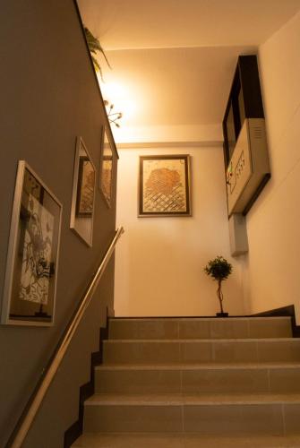 a hallway with stairs with a plant in the middle at The 168 Gallery Residence and Hotel in Chiang Mai