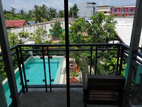 a balcony with a view of a swimming pool at JR Place in Klong Muang Beach
