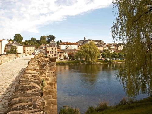 a river in a town with houses and buildings at Mercure Limoges Centre in Limoges