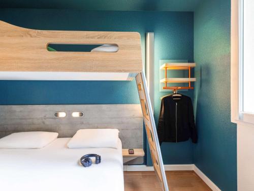 a bedroom with a bunk bed with a ladder at ibis budget Bordeaux Centre - Gare Saint Jean in Bordeaux