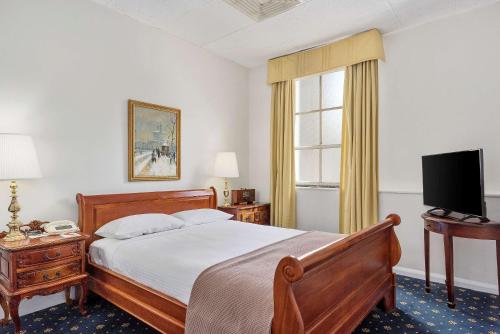 a bedroom with a large bed and a television at Castlereagh Boutique Hotel, an Ascend Collection Hotel in Sydney