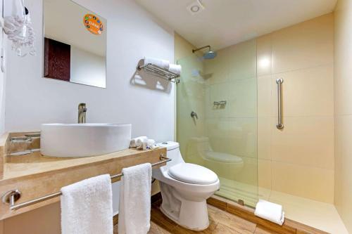 a bathroom with a sink and a toilet and a shower at Sleep Inn Mazatlan in Mazatlán