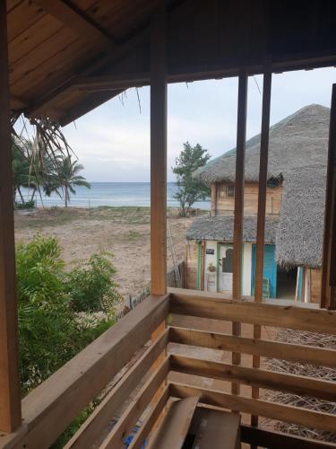 a porch of a house with a view of the ocean at Memo's Beach in Nilaveli
