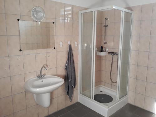 a bathroom with a shower and a sink at Bella Vendégház Mórahalom in Mórahalom