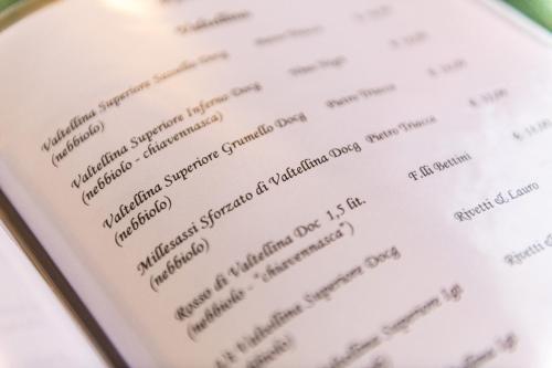 a close up of a menu on a cell phone at Hotel Club Funivia in Aprica