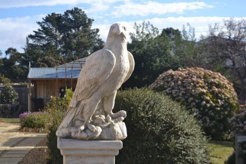 a statue of a bird sitting on a pedestal at Mulberry Cottage Unique B&B Accommodation in Richmond