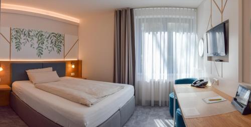Säng eller sängar i ett rum på Hotel Park Soltau